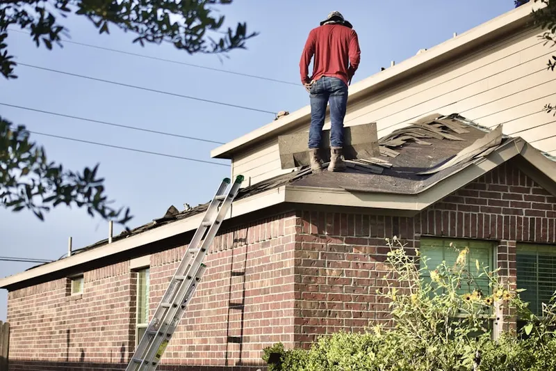 Professional roofer working on a residential roof in Willistown